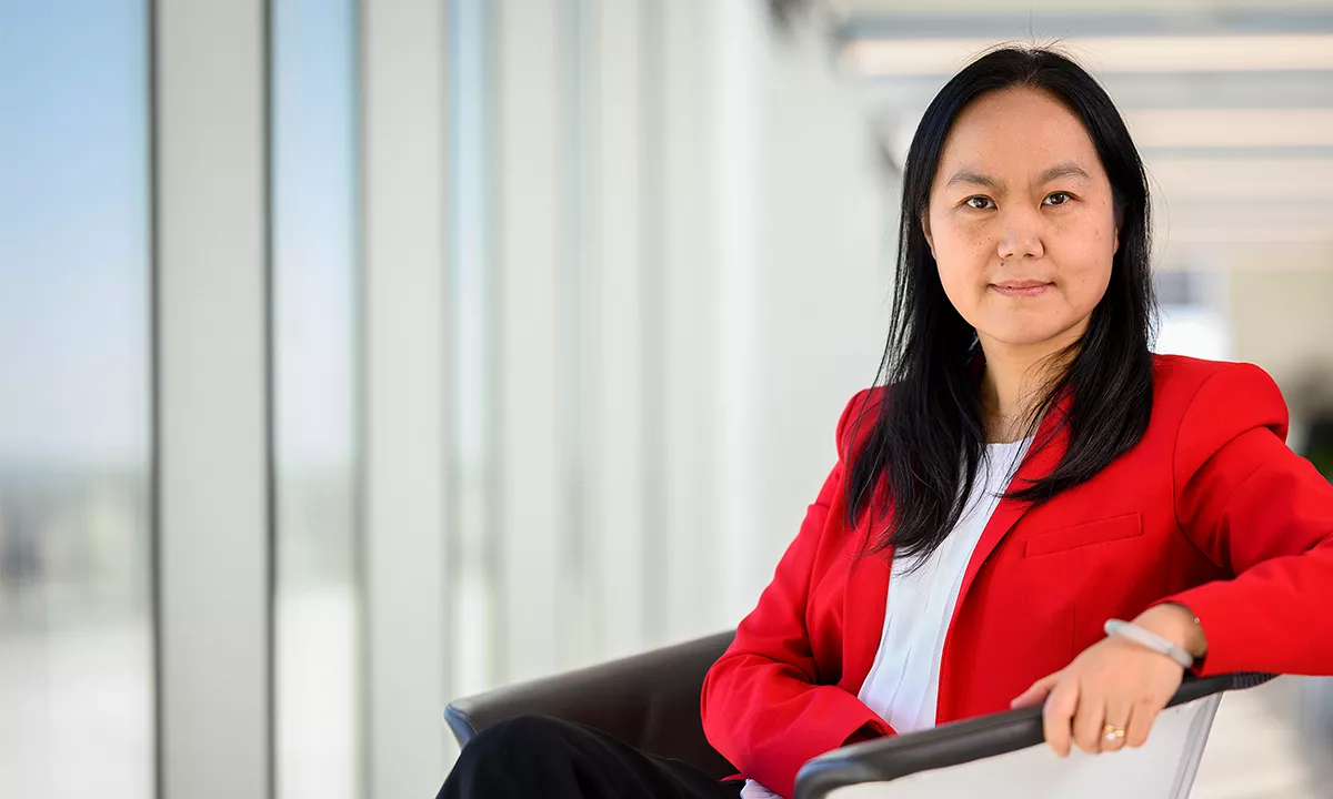 person sitting in chair smiling at camera